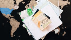 Open planners, a travel-themed notebook, maps, compass, and pen await—ideal for louisiana immigration lawyers mapping out new journeys.