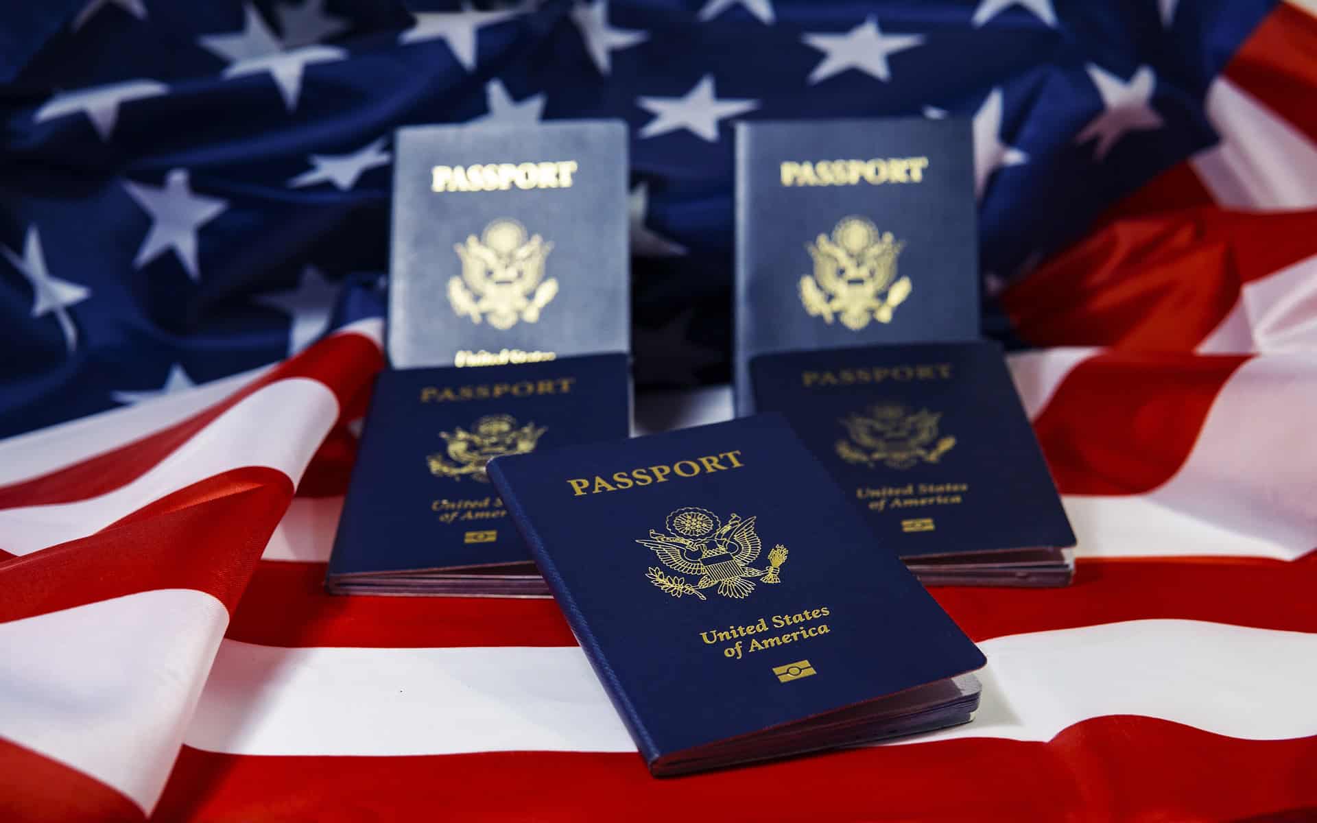 Five U.S. passports on an American flag, symbolizing journeys guided by Louisiana immigration lawyers and new opportunities ahead.