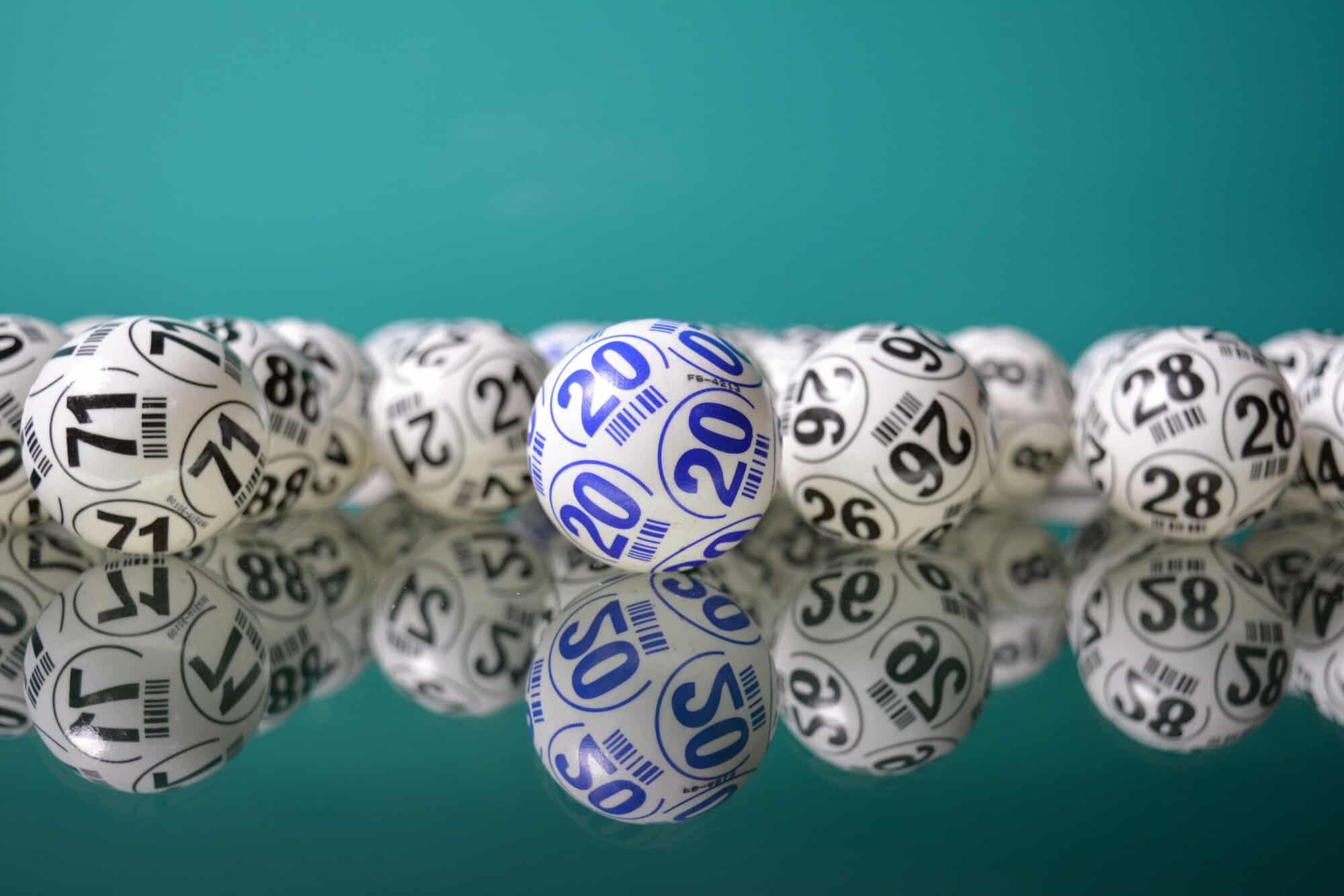 White and blue-numbered balls rest on a reflective surface, echoing the precision found in top Louisiana immigration lawyers.