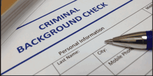 A pen rests on a criminal background check form, often reviewed by Louisiana immigration lawyers for vital personal information.