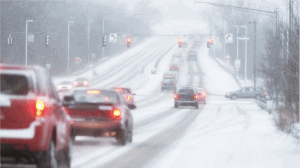 Cars driving on a snow-covered road with reduced visibility—conditions where personal injury lawyers Louisiana can help after an accident.