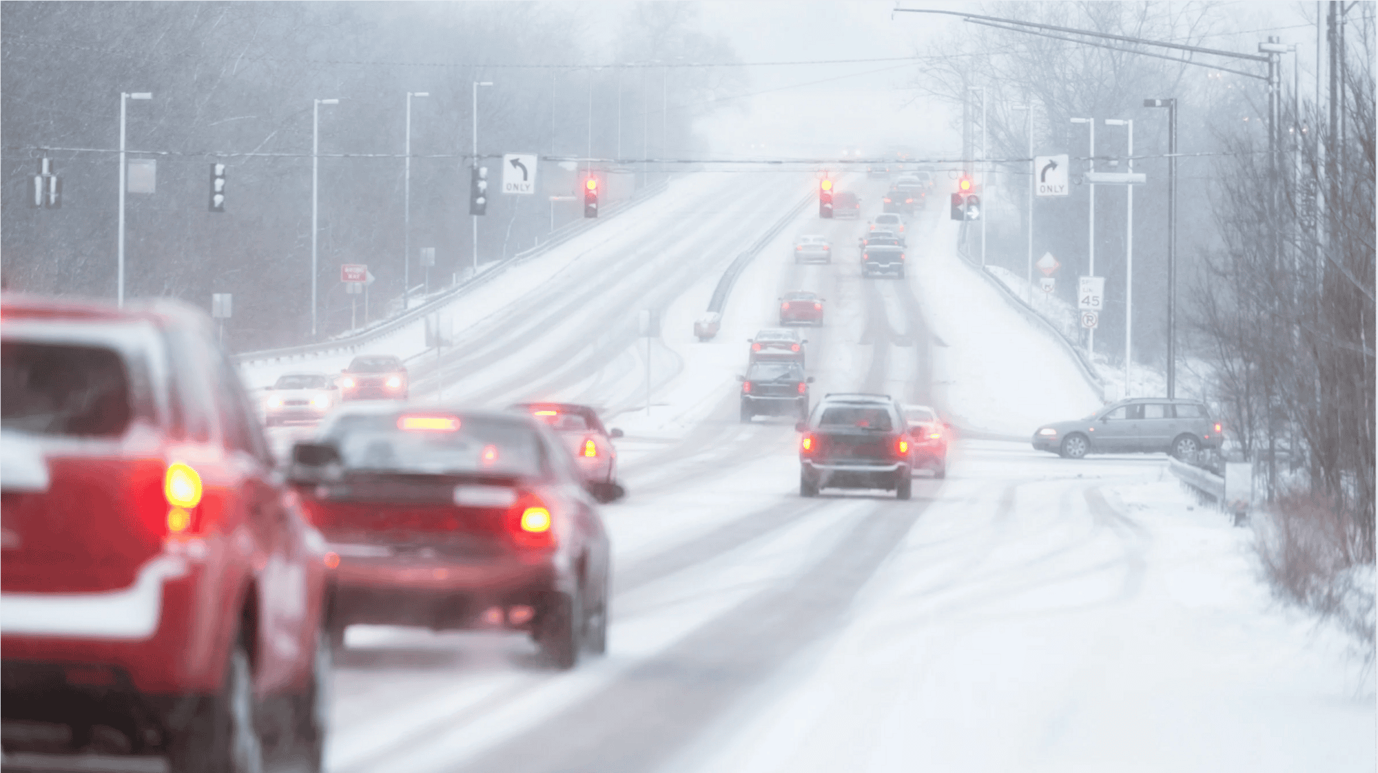 Cars driving on a snow-covered road with reduced visibility—conditions where personal injury lawyers Louisiana can help after an accident.