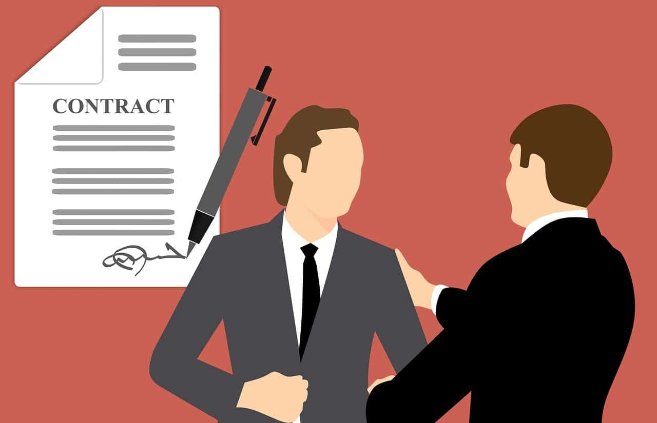 Two men in suits stand together before a signed contract, representing a trusted personal injury lawyers Louisiana team.