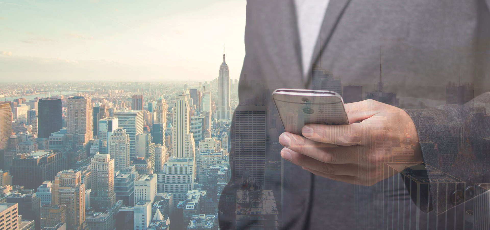 A person in a suit holds a smartphone with the city skyline behind them—perfect imagery for Louisiana immigration lawyers.