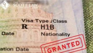 Close-up of an H1B visa with "GRANTED" stamp and The Scott Law Firm logo, leading louisiana immigration lawyers.