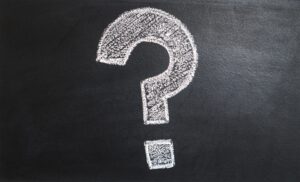 A large white question mark drawn with chalk on a blackboard hints at questions for Louisiana immigration lawyers.