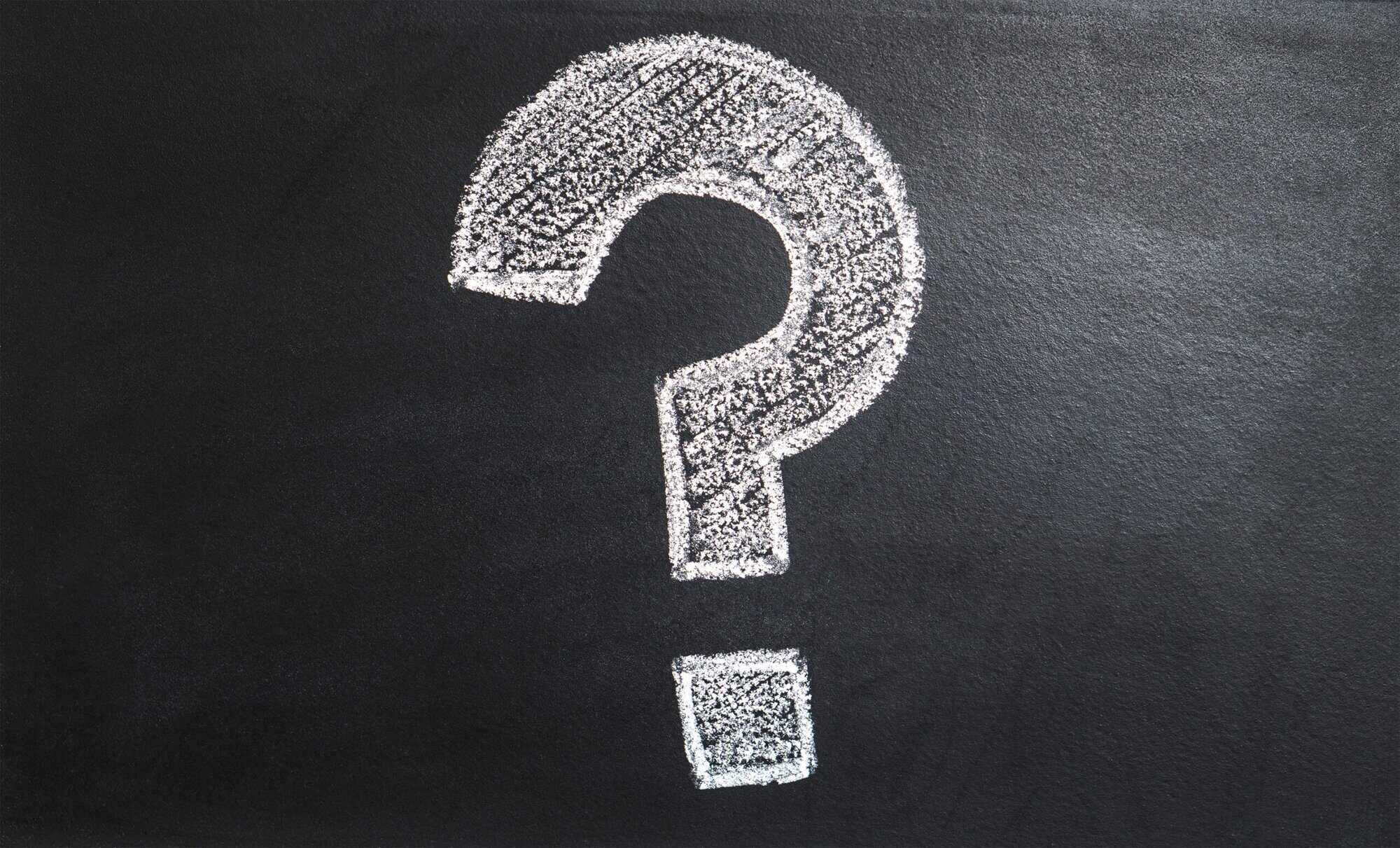 A large white question mark drawn with chalk on a blackboard hints at questions for Louisiana immigration lawyers.