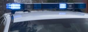 Close-up of a police car roof with blue emergency lights flashing; criminal defense lawyers Louisiana can help protect your rights.
