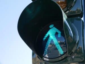 Close-up of a green pedestrian traffic light, like a beacon guiding you—just as immigration visa lawyers help navigate your legal pathway.