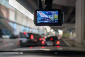 Dash Camera in vehicle as someone drives through city