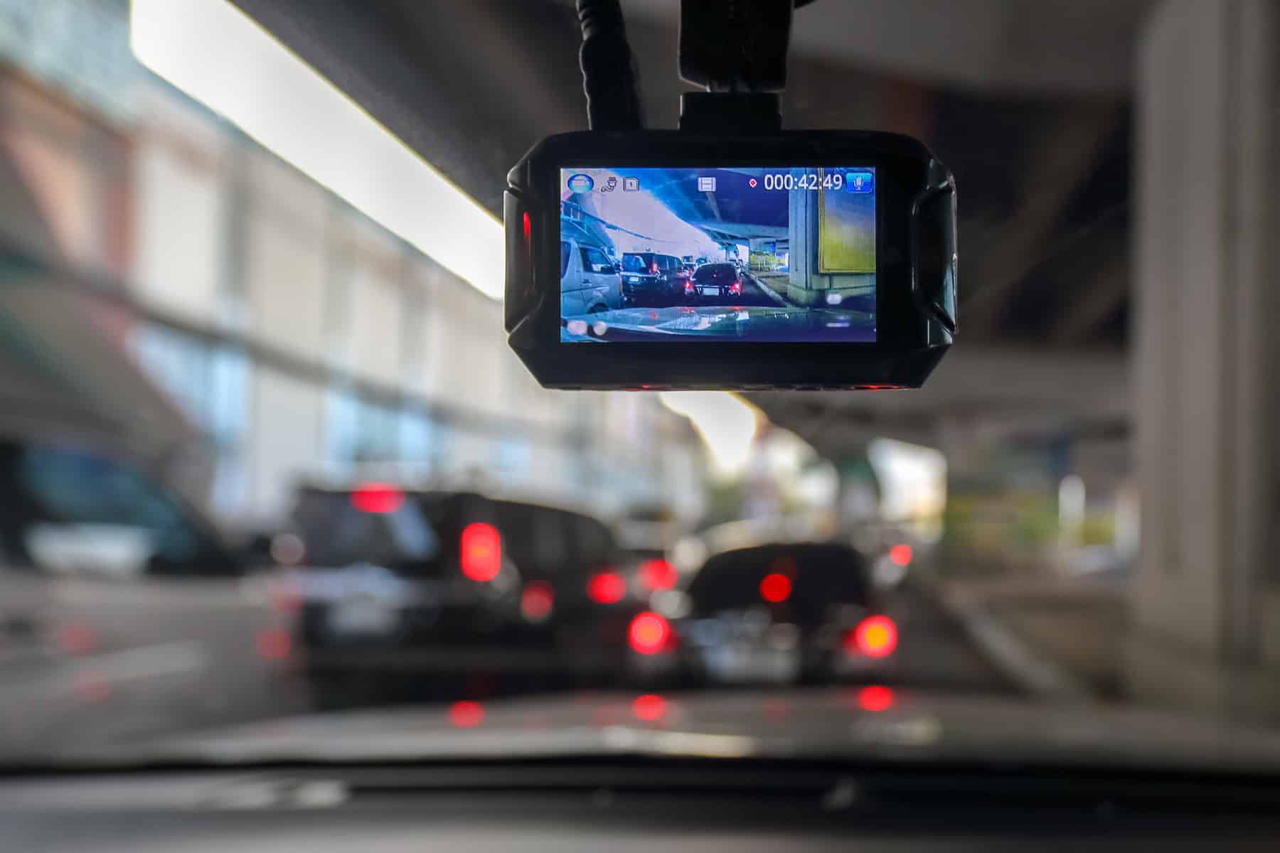 Dash Camera in vehicle as someone drives through city